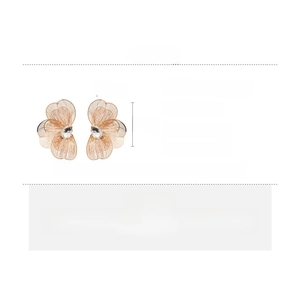 Detail showing oversized gold petal mesh earrings with crystal and size dimensions