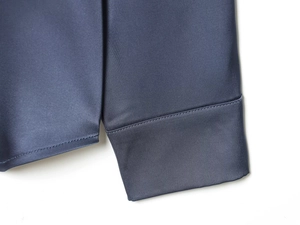 Detailed shot of the smooth satin shirt cuffs with high-quality stitching and fabric texture