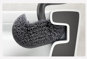 Detail showing the flexible S-shaped toilet brush head cleaning the toilet rim groove