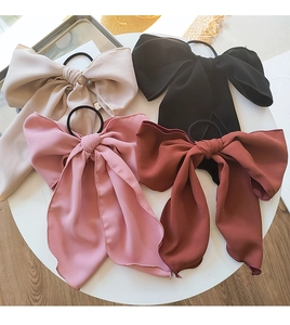 Group display of ribbon bow hair ties in beige, black, pink and brick red fabric