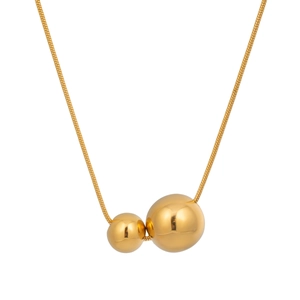 Macro detail of gold snake chain with double polished spherical pendants for women