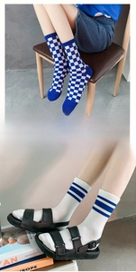 Detail showing checkered and striped crew socks with elastic cuffs and cotton texture