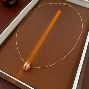 Luxury gold plated cylinder necklace with red and white pavé cubic zirconia crystals