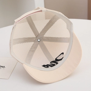 Detail of breathable mesh construction and interior stitching on beige kids baseball cap