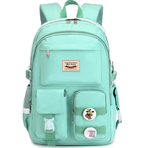 Detail of mint green school backpack featuring functional buckle pockets and decorative badges