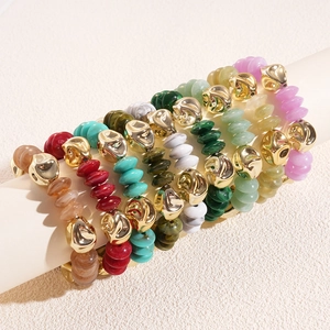Colorful resin marble bead bracelets with gold alloy accents on a white display stand