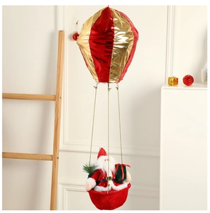 Detail of Santa Claus in a red and gold hot air balloon hanging Christmas decoration