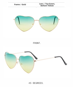 Detail of heart-shaped sunglasses with gold metal frame and green-yellow gradient lenses