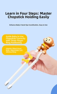 Toddler training chopsticks with yellow finger rings and cartoon monkey decoration