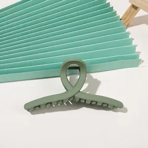 Detailed view of matte Morandi green shark hair claw clip with cross-twist design