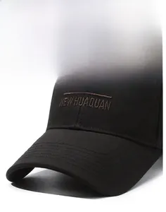Detail of reinforced stitching on black cotton baseball cap brim with embroidery