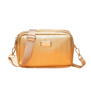 Fashionable golden camera bag with wave texture and beige wide strap on white background