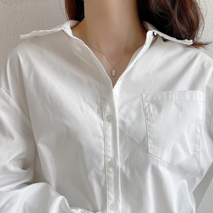Irregular 925 sterling silver necklace shown on model with white embroidered shirt