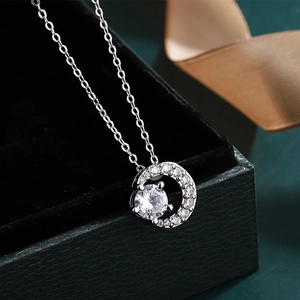 Macro shot of 2 carat round cubic zirconia pendant on silver necklace with premium gift box