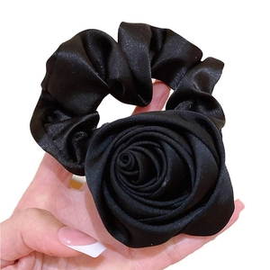 Elegant black satin rose hair scrunchie with silky finish and large floral design