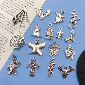 Detailed view of antique silver Halloween alloy charms featuring ghost and bat designs
