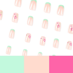 Green French tip press-on nails with cute pink floral patterns and white background