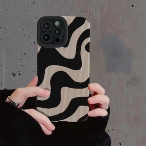 Minimalist zebra wavy stripe pattern phone case for iPhone series held against a wall