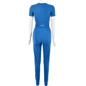 Back view of women's blue ribbed two-piece set featuring cropped top and high waist pants
