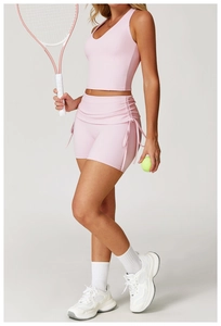 Pink yoga set featuring V-neck tank top and side drawstring shorts on high-elastic fabric
