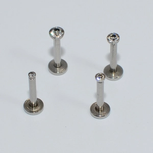 Detailed view of stainless steel labret studs with clear cubic zirconia in various lengths