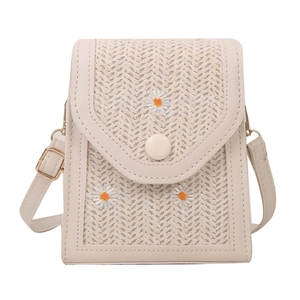Beige straw woven mini crossbody bag with daisy embroidery and adjustable PU leather strap