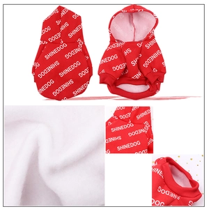 Detail view of red pet hoodie with white SHINEDOG lettering and soft fleece fabric texture
