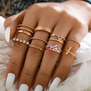 Bohemian gold ring set with mountain design and crystals on white faux fur background