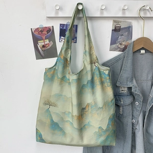 Detail of vintage canvas tote bag with mountain landscape print in green and yellow