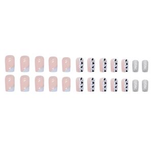 Blue and white French tip press-on nails with pink glitter and heart patterns