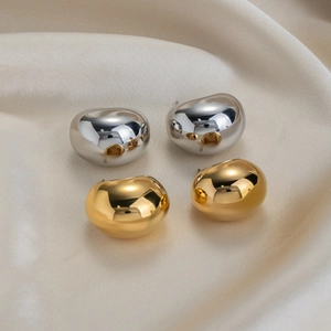 Minimalist organic bean shaped stud earrings in polished gold and silver finish