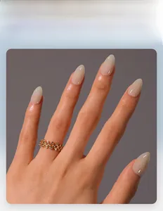 Detail of nude pink glossy almond press-on nails with a minimalist professional finish