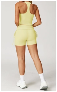Rear view of yellow yoga set with racerback top and high-waist drawstring gym shorts