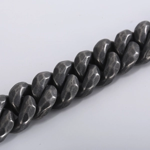Close-up of vintage distressed silver Cuban chain bracelet with hammered texture details
