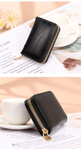 Detailed macro view of black crocodile pattern card holder with a golden metal zipper