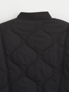 Macro view of wave quilted pattern and ribbed collar detail on black jacket