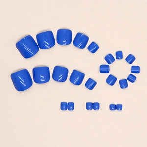 Glossy sea blue press-on toe nails in various sizes on a beige background for summer
