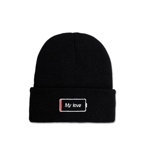 Detail of the black knitted beanie featuring My Love battery embroidery on the folded cuff