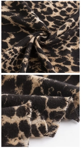 Close-up of leopard print scarf fabric texture and fine fringe edge detail