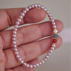 Detailed view of freshwater pearl bracelet with agate and jade beads on a wrist