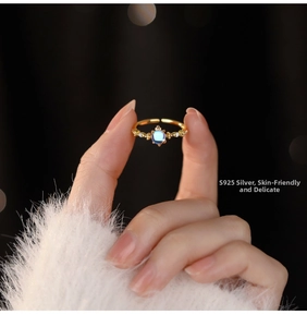 Detailed close-up of s925 silver moonstone ring with side diamonds on model's hand