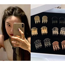 Set of 12 mini metallic claw clips in gold and silver shown on hair and in box