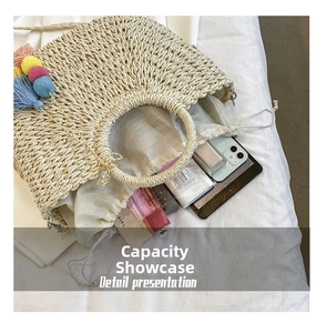 Straw bag interior detail showing large capacity for phone, perfume and cosmetics