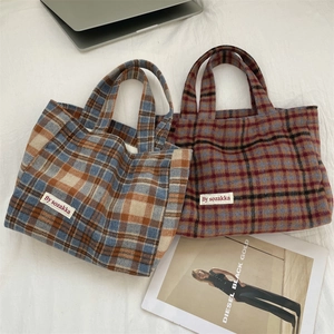 Detailed close-up of two plaid tote bags in wool fabric for autumn and winter office use