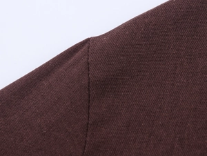 Macro shot of chestnut brown linen blazer showing shoulder seams and fabric texture