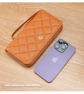 Orange quilted wristlet wallet and phone bag size comparison with an iPhone mobile