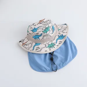 Detail of dinosaur print kids sun hat with breathable mesh and blue neck protection flap