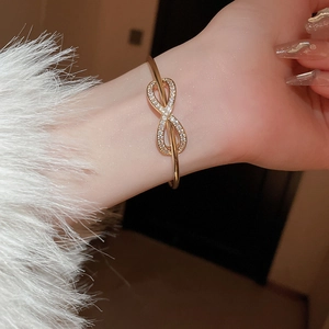 Elegant gold infinity bangle featuring sparkling zircon crystals for a luxury women's style
