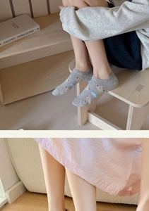 Detail of grey cotton ankle socks with cute bear pattern and CUTE text embroidery