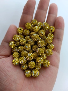 Macro view of 10mm yellow Shamballa disco bead with sparkling micro-rhinestones and hole